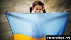 Fetiță ucraineană la un miting organizat în București, în care refugiații cereau liderilor mondiali să condamne agresiunea Rusiei. 