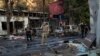 A Ukrainian military member walks past burned cars at a market following a Russian strike in Kostyantynivka, Ukraine's eastern Donetsk region on September 6, 2023, amid the Russian invasion of Ukraine.