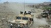 Afghan security forces patrol during an ongoing an operation against Islamic State (IS) militants in Kot district of Nangarhar Province on February 16.
