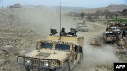 Afghan security forces patrol during an ongoing an operation against Islamic State (IS) militants in Kot district of Nangarhar Province on February 16.