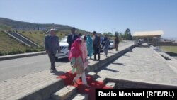 Malala Yousafzia (center, in red) arrives with her family during a visit to Mingora on March 31.