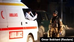 An Afghan soldier stands guard as ambulance arrives at the site of an attack in Kabul late on December 24.