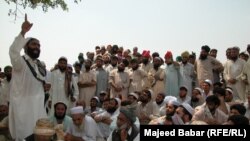 A tribal jirga or council in the Khyber tribal district debate the fate of minority Sikhs threatened by a fanatical cleric in 2002.