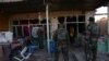 FILE: Afghan National Army soldiers inspect buildings after clashes with militants.