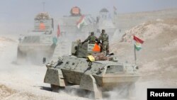 Kurdish Peshmerga forces advance in the east of Mosul to attack Islamic State militants in the city on October 18. 