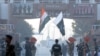 Pakistani Rangers (in black) and Indian Border Security Force personnel take part in the daily retreat ceremony at the India-Pakistan Wagah Border Post in Kashmir on December 18.