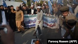 Pakistani student members of an Islamist party burn images of U.S. President Donald Trump during a protest against U.S. aid cuts in Islamabad on January 5