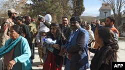 Pakistani Christians are evacuated by security personnel from a Methodist church after a suicide bomber attacked during a Sunday service in Quetta on December 17.