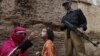 FILE: A polio worker administers polio vaccine to a child, in Peshawar, the provincial capital of Khyber-Pakhtunkhwa