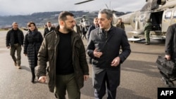 Ukrainian President Volodymyr Zelensky (left) is welcomed by Swiss Foreign Minister Ignazio Cassis upon his arrival at Bern airport on January 15.