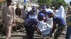 Pakistani rescue workers carry a body of a victim at the scene of a suicide bomb blast in Quetta, June 23, 2017