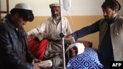 Relatives tend to an injured blast victim at a hospital in Kurram tribal district on January 30.