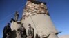 Afghan soldiers stand guard at the checkpoint in Khwaja Omari district of Ghazni Province on April 12.