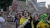 Protesters shout slogans and hold placards during a demonstration against a law that removes the independence of the NABU and SAPO anti-corruption agencies, in Kyiv on July 24, 2025, amid the Russian invasion of Ukraine