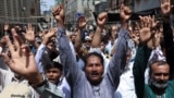 Pakistani Shi'ite Muslims in Karachi raise their hands and chant slogans as they attend an anti-Israel protest on June 13 following its strikes on Iran. 
