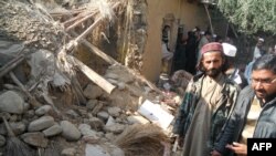 FILE: Islamic students gather at the site of a suspected U.S. drone strike against the Haqqani network the Hangu district of Khyber Pakhtunkhwa province. The region borders Kurram tribal district.