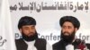 FILE: Muhammad Naeem (R), a spokesman for the Office of the Taliban of Afghanistan speaks during the opening of the Taliban Afghanistan Political Office in Qatar, June 2013.