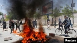 Protesters set a fire during a protest in Kabul on June 2.