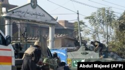 Pakistani soldiers outside an Agriculture Training Institute after an attack by Taliban militants in Peshawar on December 1.