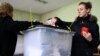 Kosovo - A young girl casts her vote at a polling station in Pristina, 15Nov2009