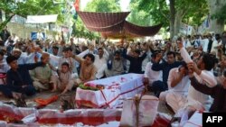 Pakistani Shi'ite Muslims stage a protest on June 30 against the killing of their community members in twin bomb blasts at a market in Parachinar, capital of Kurram tribal district on June 24.