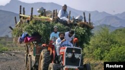 FILE: An internally displaced family flee Tora Warai, a village in Kurram tribal district.