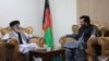 Former Afghan warlord Gulbuddin Hekmatyar (left) speaks to Laghman Province Governor Abdul Jabar Naimi on April 28.