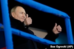 Russian President gives two thumbs up during the opening ceremony of the 2022 Winter Olympics in Beijing.