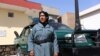 FILE: An Afghan female police officer stands guard outside a police station in Herat (October 2017).